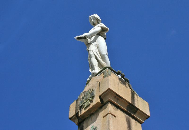  The angel, who lost his wings during a cyclone, holds the laurel wreath
